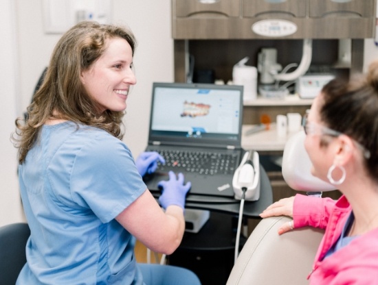 Dentist talking to a patient in the dental chair