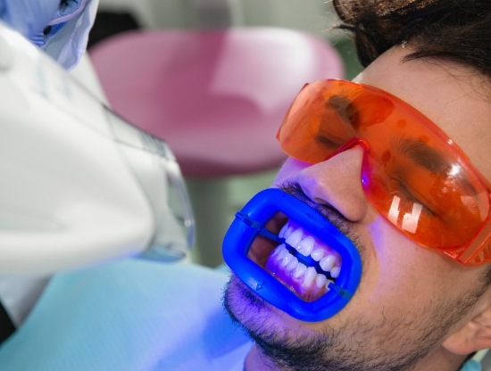 Man in dental chair having his teeth professionally whitened