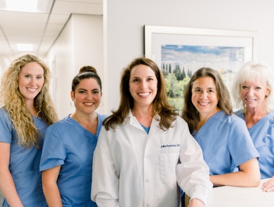 Doctor Karpman smiling with her dental team members