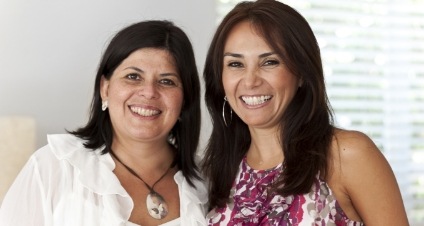 Two brunette women grinning together