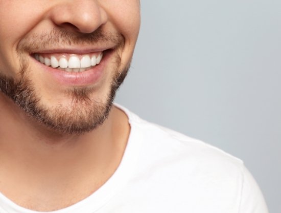 Close up of man with short facial hair smiling