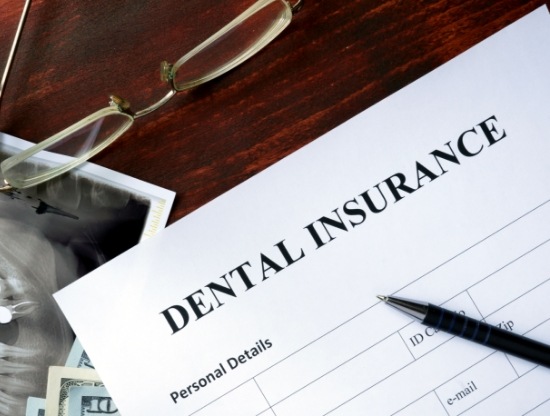 Dental insurance paperwork on wooden desk