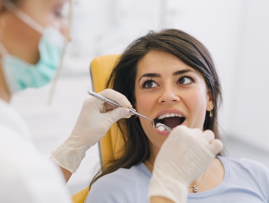 Woman in dental chair receiving a tooth extraction in Rocky Hill