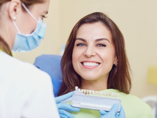 Dental patient smiling while receiving veneers