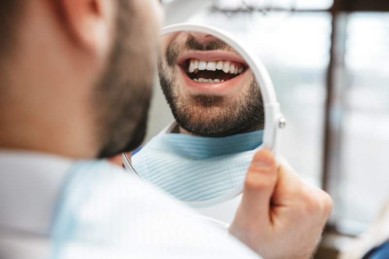 Patient smiling after getting cosmetic dentistry